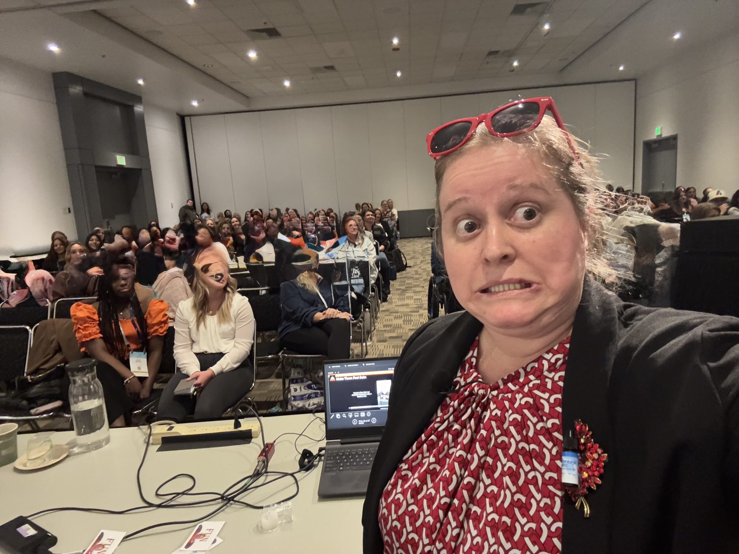 group of people watching a video while Dr. Brooke takes a selfie